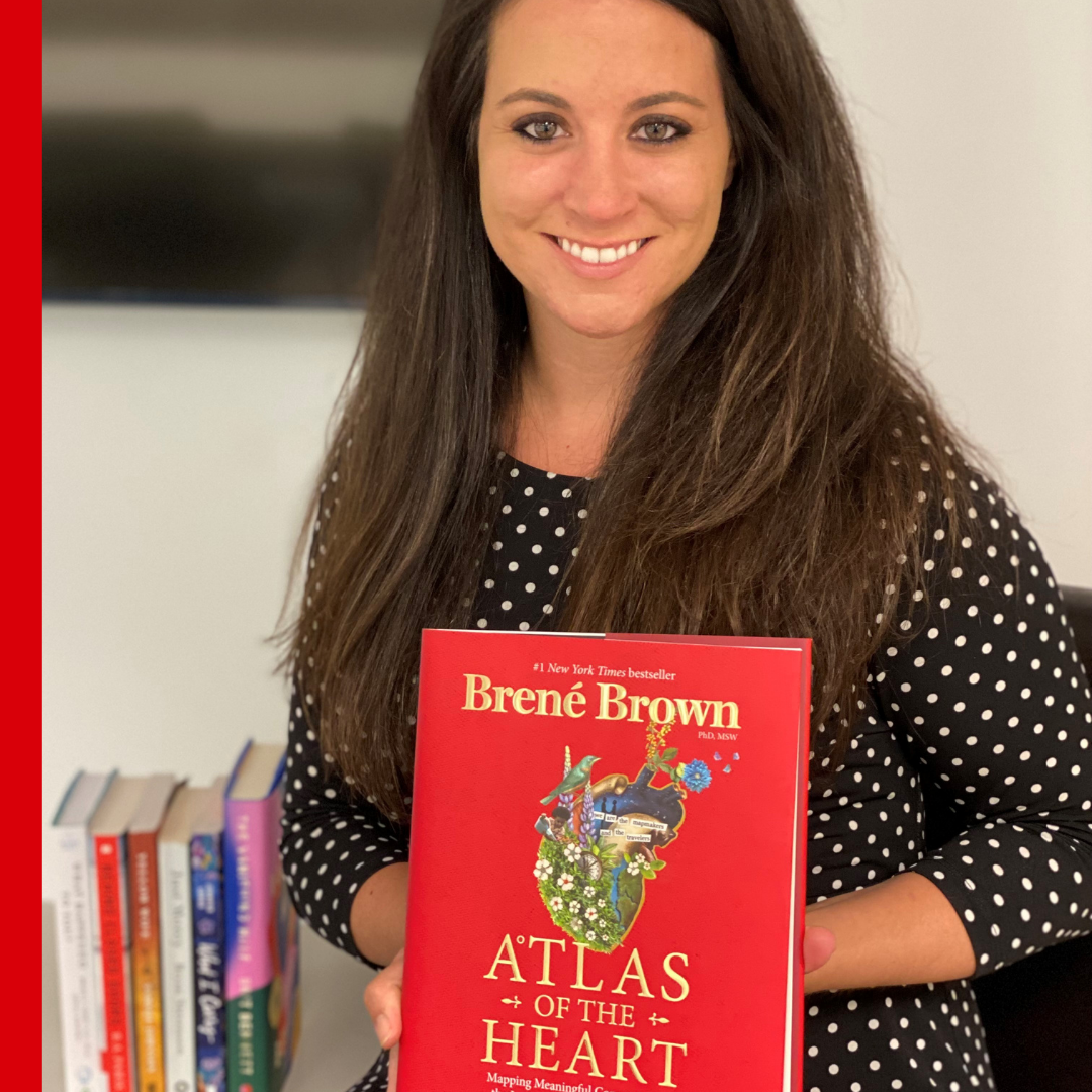Jeannine holding Atlas of the Heart by Brene Brown