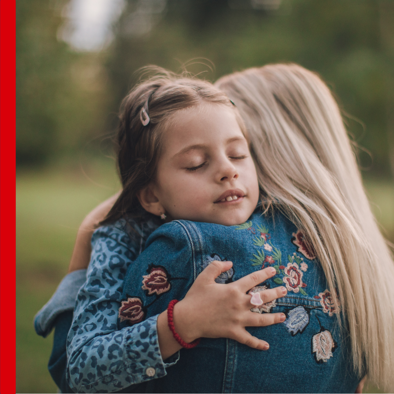 Adult hugging child